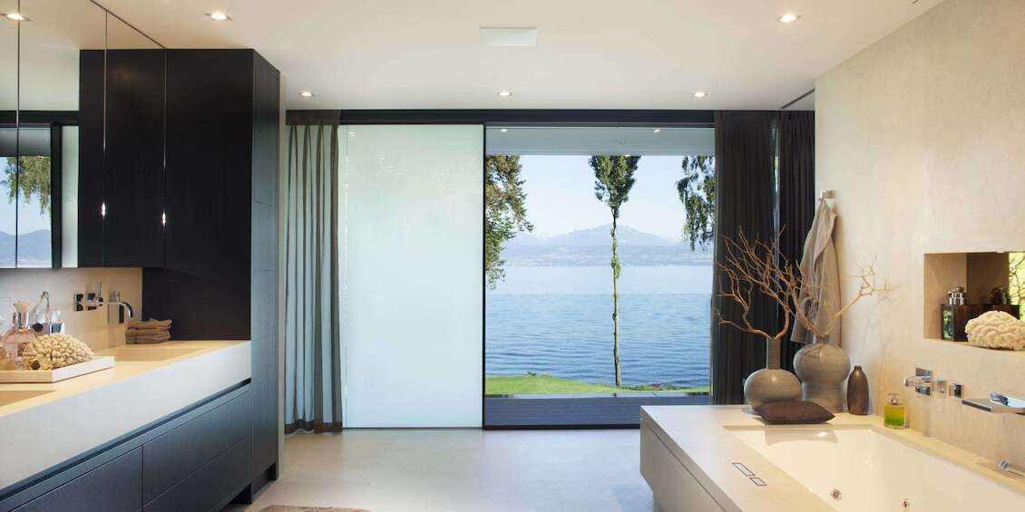 Bathroom with large sliding windows and privacy screen