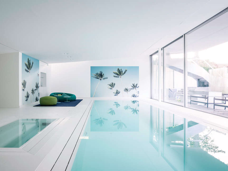 Frameless windows in the pool area can be opened at the touch of a button