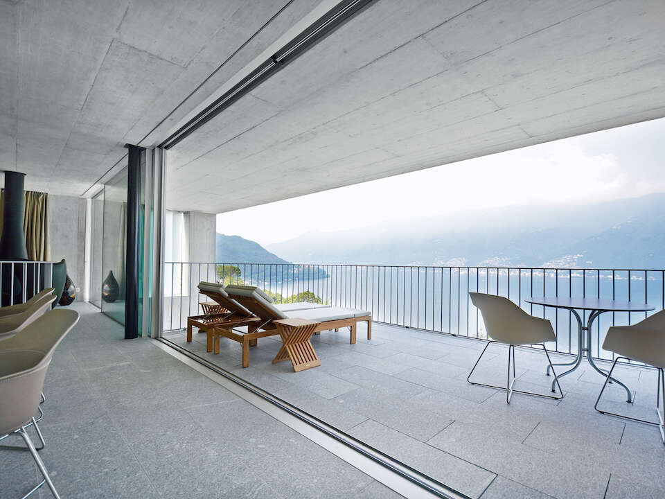Concrete house with panoramic windows and terrace